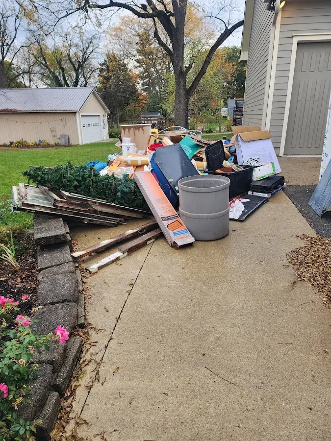Dumpster being loaded with debris for 10 Yard Dumpster Rental in Oak Lawn